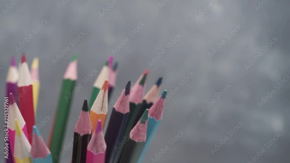 Poster colored pencils, rotation 360 degrees. dark bacground. macro view.