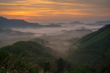 Sunset mountain silhouette fog