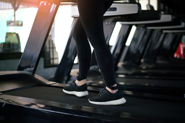 Fototapeta na wymiar Female fitness run on treadmill