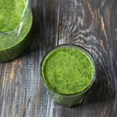 Green smoothies with kale, banana and lemon. on a wooden table. selective focus. healthy diet food