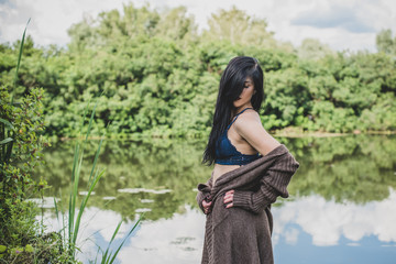 Fashionable woman with pale skin and dark hair. Photo of dreamy american girl posing at  romantic photoshoot. Concept of femininity and grace 