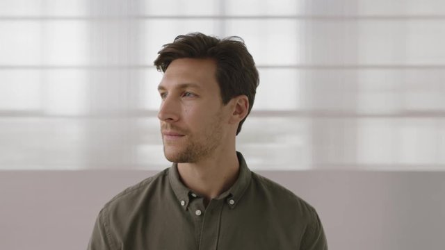close up portrait of young entrepreneur man looking serious pensive at camera turns head