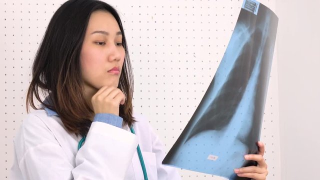 Female doctor examining X-ray image
