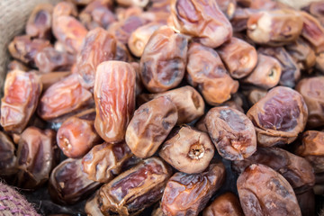 Dried dates Fruit close-up background/ Dried dates Fruit close-up in a canvas bag in the Arab market. Dried dates Fruit background