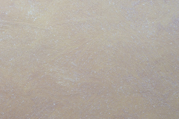 Obraz premium Brown wall decorated with a solution of clay with white patches.