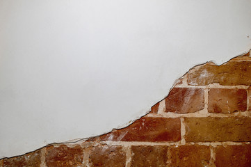 Part of the red brick wall of an old house with a figured pattern of white putty. Background, contrasting texture.