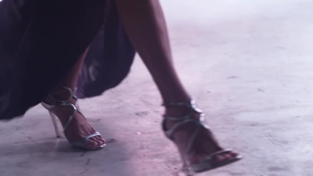 walking on high heels with dramatic smoke effect