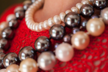 Strings of beads on the red blouse.
