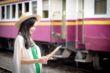 Fototapeta na wymiar Asian woman traveler has waiting the train at Hua Lamphong station at Bangkok, Thailand.