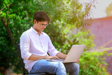 young Indian man using laptop , Working on Laptop