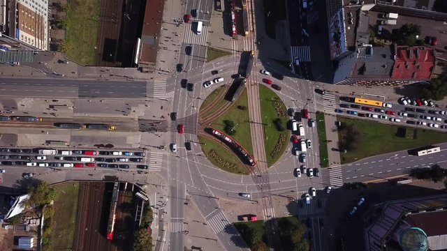 Top view of the road junctions. Aerial survey of highways of the road network. Cars moving at the intersection and denouement. Organization of traffic from a bird's eye view. Summer road.