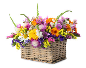 Fototapeta na wymiar Wicker basket with beautiful wild flowers on white background