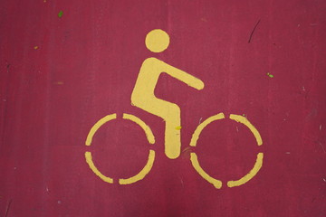 yellow sign bicycle lane in red road