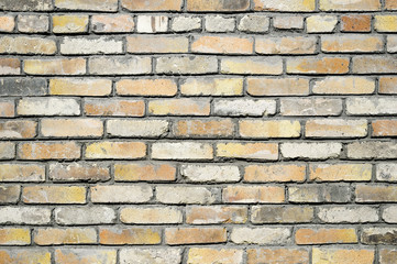 Obraz premium Part of the wall of an old house outside of red brick with white splashes removed putty for restoration.