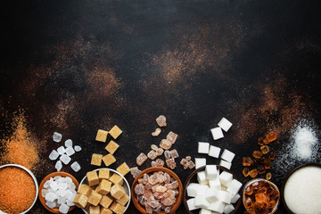 Set of different white and brown sugar in assortment, dark background, top view - obrazy, fototapety, plakaty
