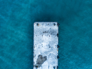 close up overhead view of ocean sea pier simple concept isolated design