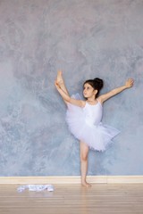 Obraz na płótnie Canvas Little girl ballerina in a white tutu
