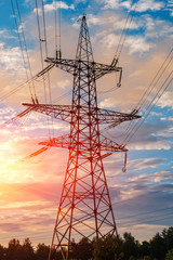 high-voltage power lines at sunset. electricity distribution station .