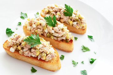 cod liver, pickled cucumber, onion, and egg salad on cristini