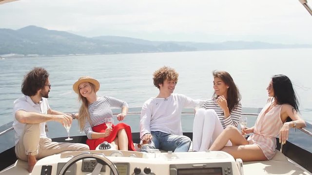 Group of Caucasian high school students participating in sea excursion to picturesque islands along Carribean Sea. Businessor educational travelling on yacht. Cruise vacation.