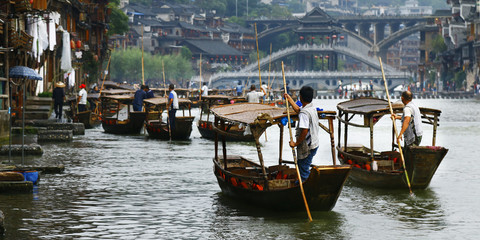 Fototapeta na wymiar Boat man on the river in fenghuang old city,China