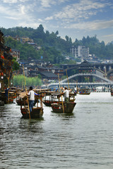 Fototapeta na wymiar Boat man on the river in fenghuang old city,China