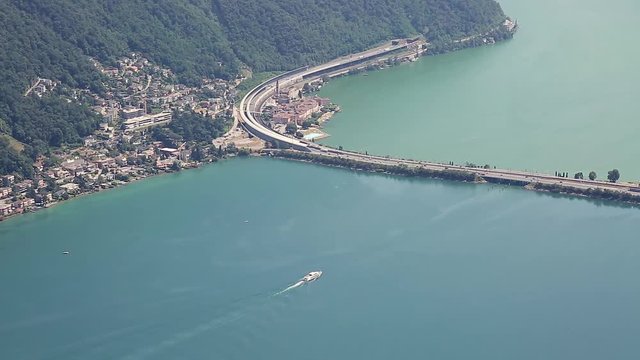 Timelapse of boats and cars over bridge in Lugano