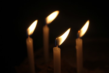 candles burning brightly on black background