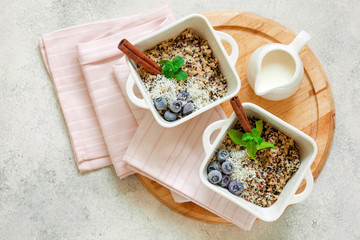 Healhty vegan breakfast bowl. Quinoa with cinnamon and fresh berries overhead