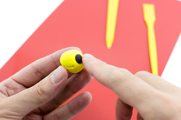 Hands Crafting Figure Out of Ball of yellow Modeling Clay