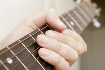 Close Up of Fingers on an Acoustic Guitar Neck