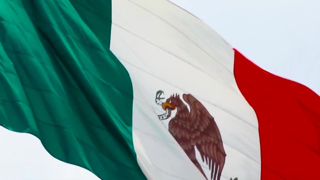 Real Mexican flag waving in the wind in slow motion. The mexican flag is a national symbol of Mexican independence on September 16