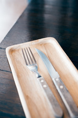 Fototapeta na wymiar Steel Knife on wood table at restaurant 