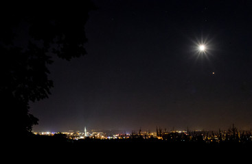 Fototapeta premium The full moon over the city of Ulm on the Danube in Germany