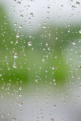 Raindrops on window against defocused blurred background.