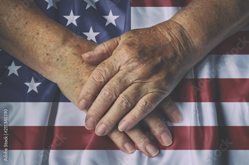 Old woman's hands with American flag