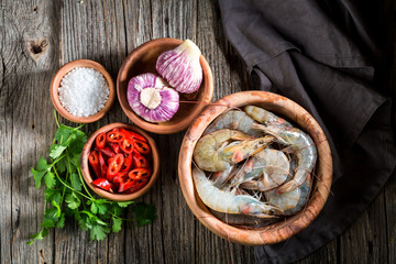 Ingredients for tasty homemade shrimp on wooden bowl