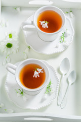 To cup of tea with honey on white background