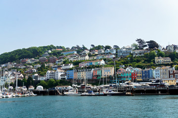 Fototapeta premium Dartmouth, Devon, United kingdom 25 may, 2018. boats and yachts, colorful houses, hotel on Dart river on summer day