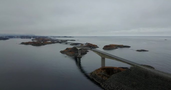Drone flying over car passing Storseisund bridge, Atlantic Road (Atlanterhavsveien) in Nynorsk, Norway.