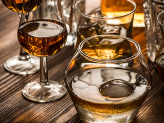 Varous glasses of whiskey on a table