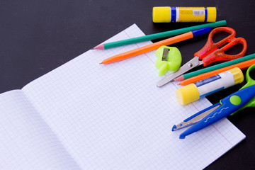 school supplies on chalkboard background