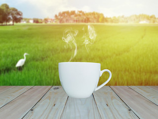 Espresso on wood table nature background sun effect