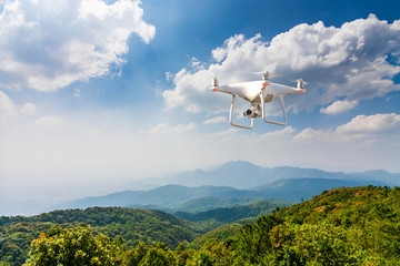 Fototapeta na wymiar flying drone above green mountain