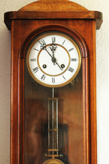 Antique wooden clock with pendulum. 