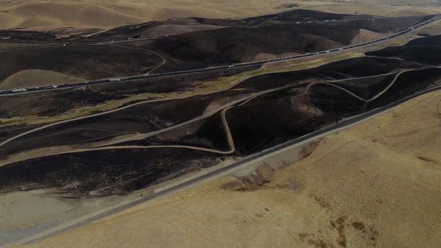 Aerial footage of a 650 acre fire started in the Altamont hills between Tracy and Livermore in California.