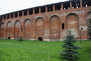 Russia, Smolensk fragment of the Smolensk red brown brick wall in the summer cloudy day