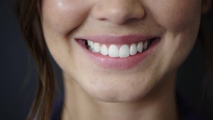 close up woman mouth smiling showing healthy white teeth dental health concept