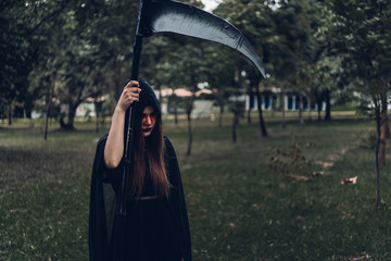 Portrait woman ghost demon she holding reaper in forest