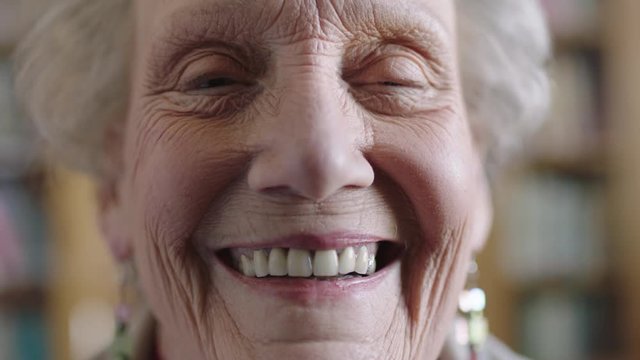 close up portrait of cheerful elderly woman smiling happy looking at camera enjoying retirement